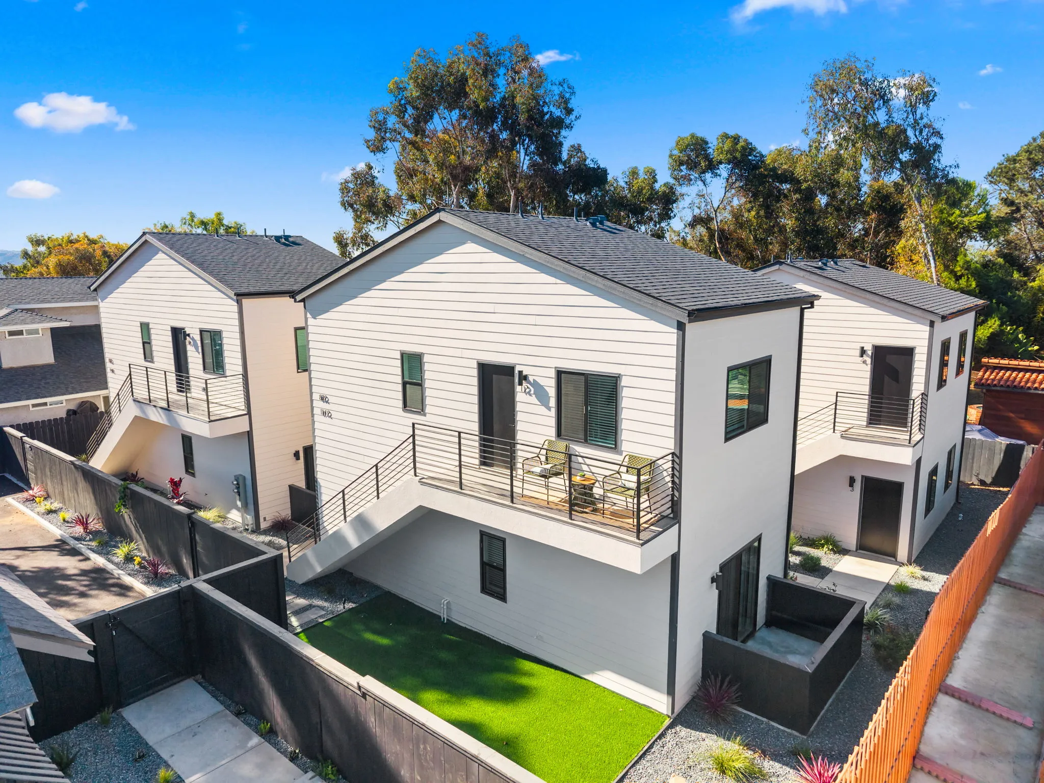 Aerial view of a modern multi-family property with private balconies